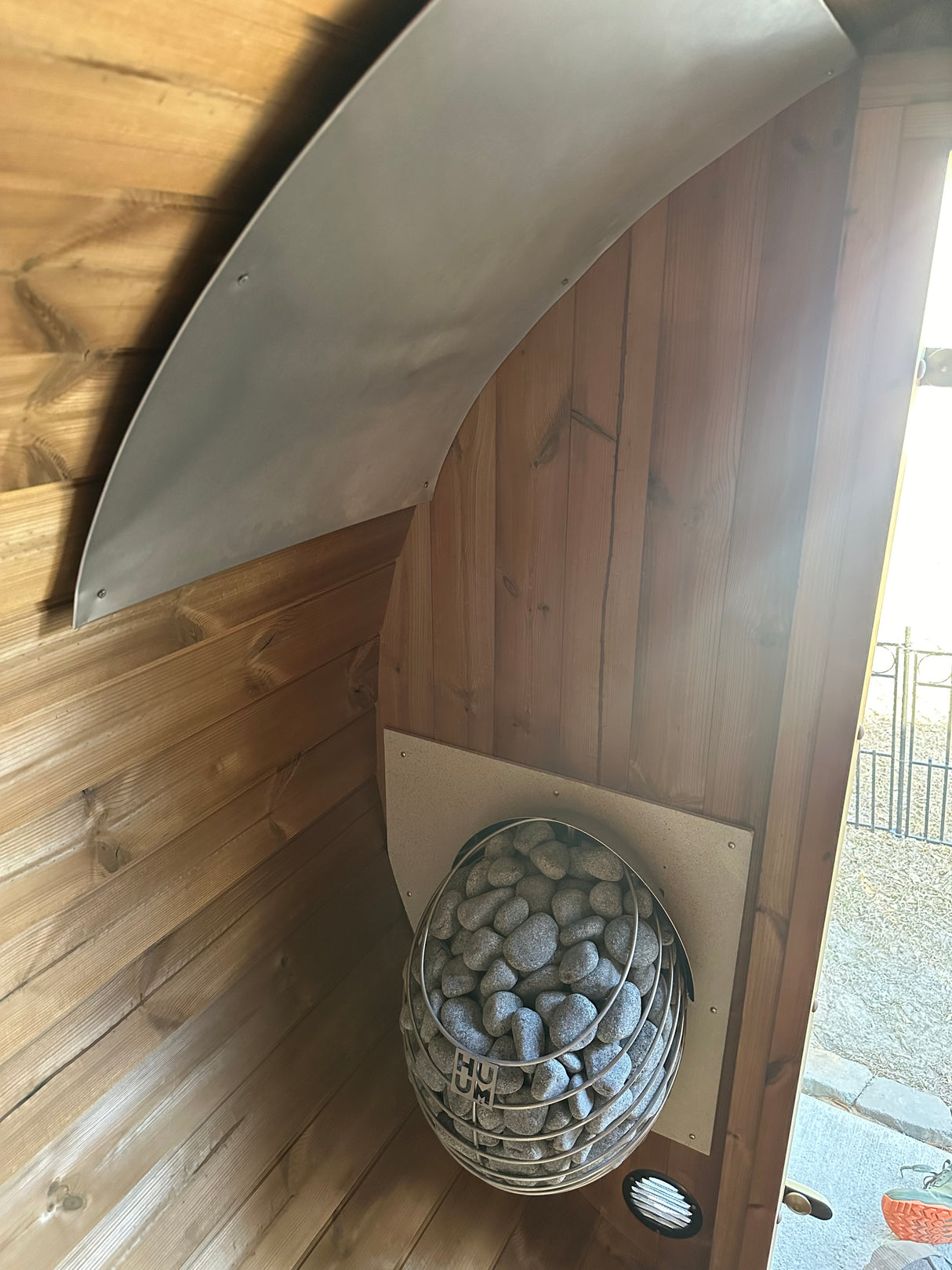 Inside the of Nordic II 3-person Barrel Sauna made of wood 